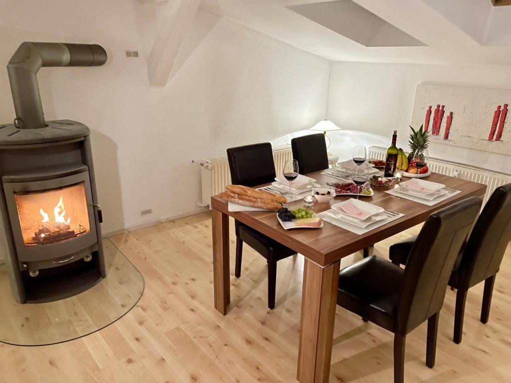 a dining room with a table and a wood stove at Ferienwohnung Alte Feuerwehr in Ueckermünde