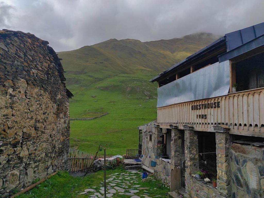 un edificio sul fianco di una montagna di Guesthouse Ivas a Ushguli