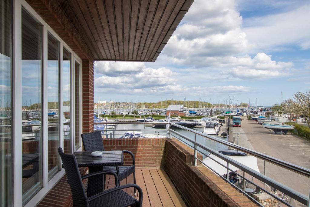 a balcony with two chairs and a view of a marina at ancora Marina Haus 2 Nr 06, Typ 2 in Neustadt in Holstein