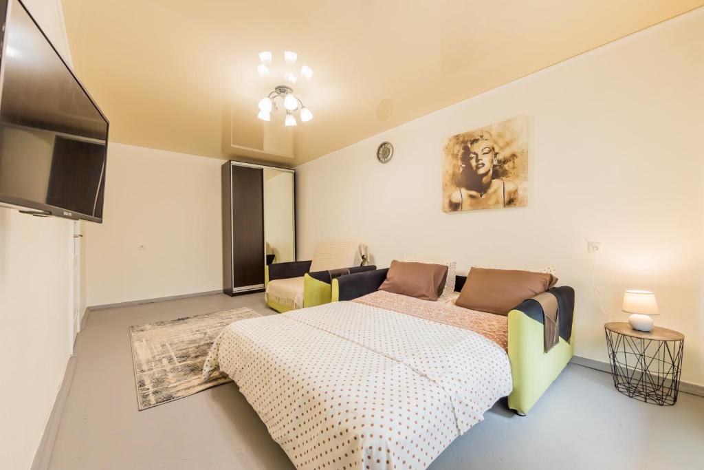 1 dormitorio con cama y sofá en Уютная квартира на Печерске, en Kiev