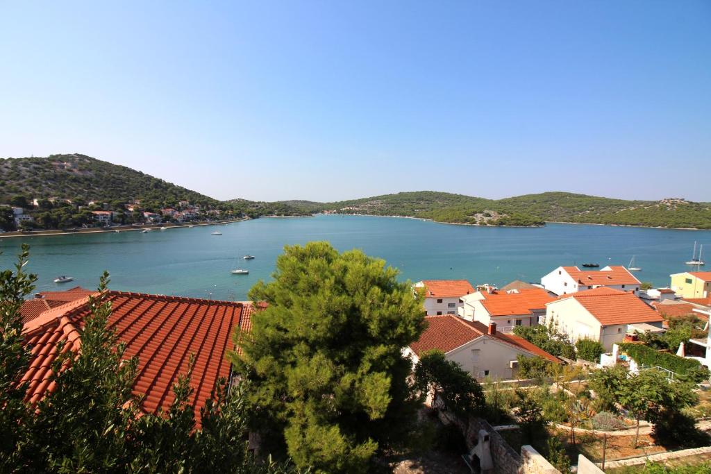 a view of a river with houses and a town at APARTMANI JADRANKA s pogledom na more in Tisno
