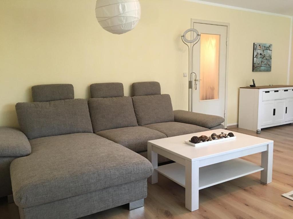 a living room with a couch and a coffee table at FEWO Ostsee Oase in Eckernförde