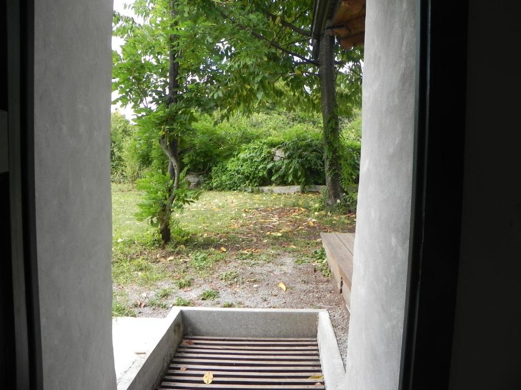 a window view of a garden from a house at Apartmaji Hedera in Komen