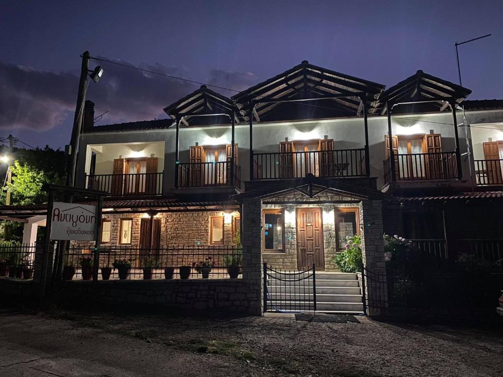 a brick house with lights on at night at Hotel Antigoni in Neochori