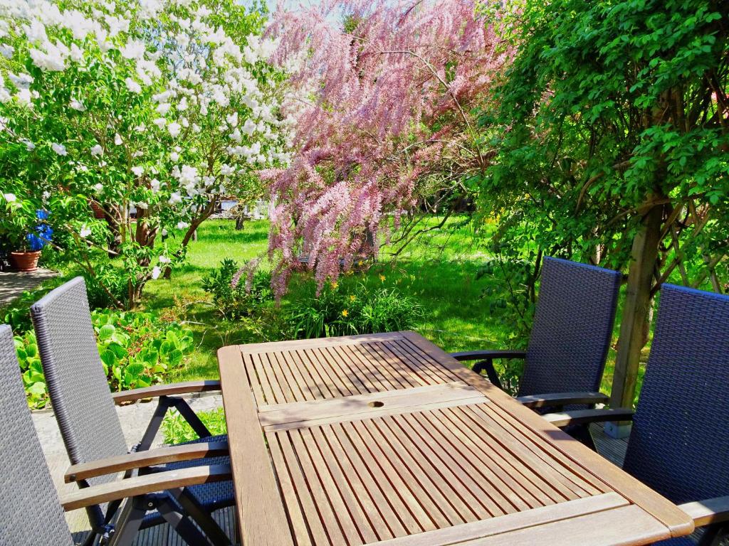 a wooden table and chairs sitting on a patio at Theil, Wolfgang in Zingst
