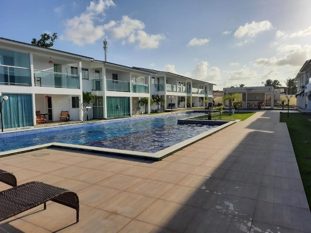 a swimming pool in front of a building at Excelente Bangalô/duplex em Jacumã - PB in Conde