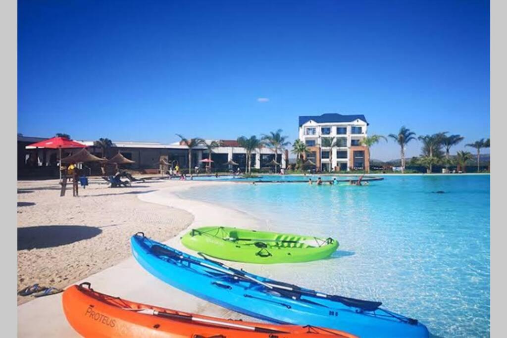 two canoes on a beach next to the water at The Blyde Silverlakes in Boschkop