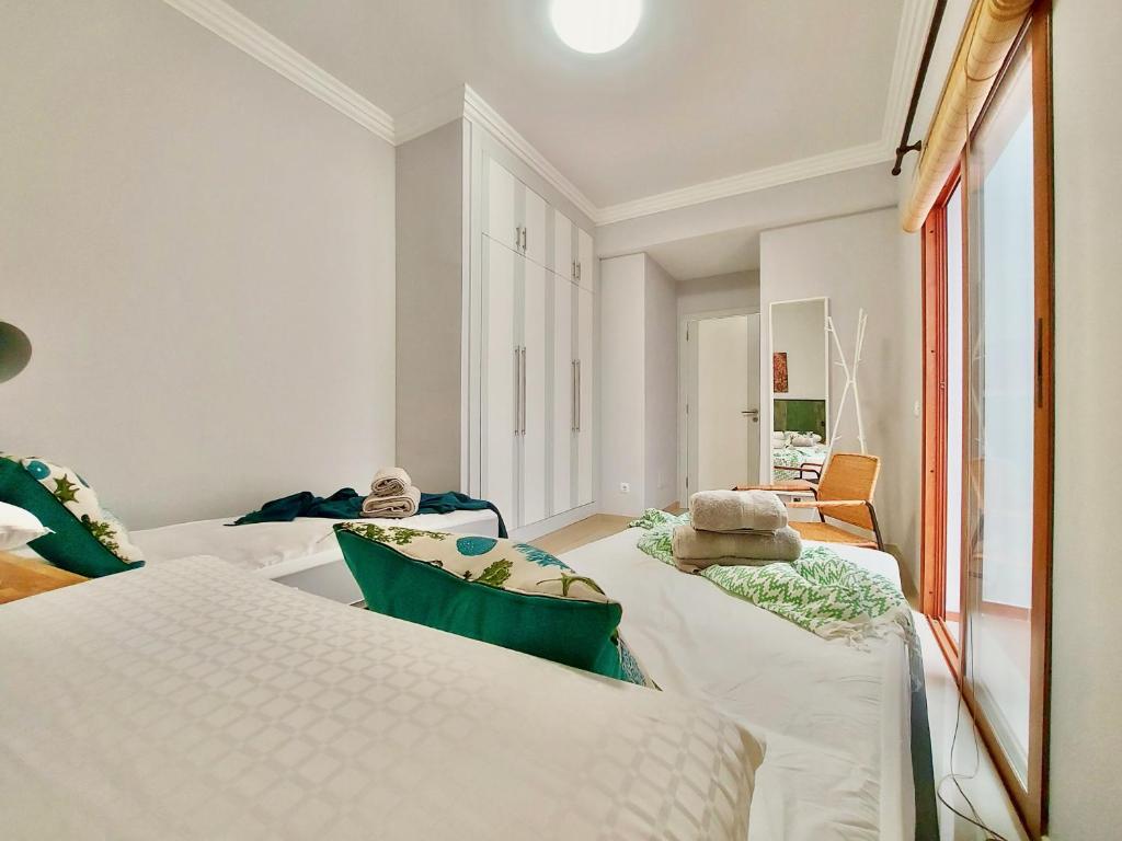 Posteľ alebo postele v izbe v ubytovaní Aromas Suites Apartments