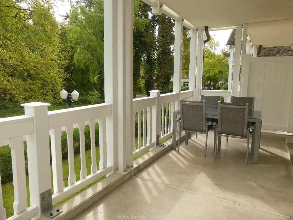 a patio with a table and chairs on a porch at Dünenpark Binz - Fewos by Sander in Binz