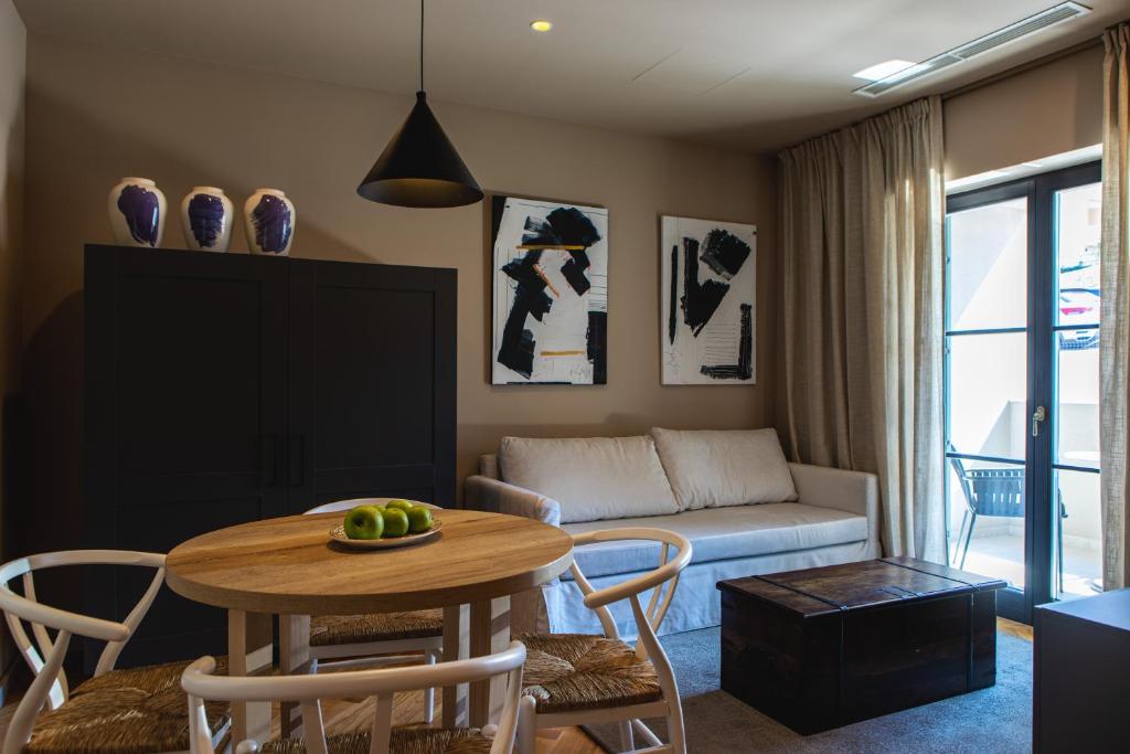 a living room with a table and a couch at DESIGN hotel VERBENICUM in Vrbnik