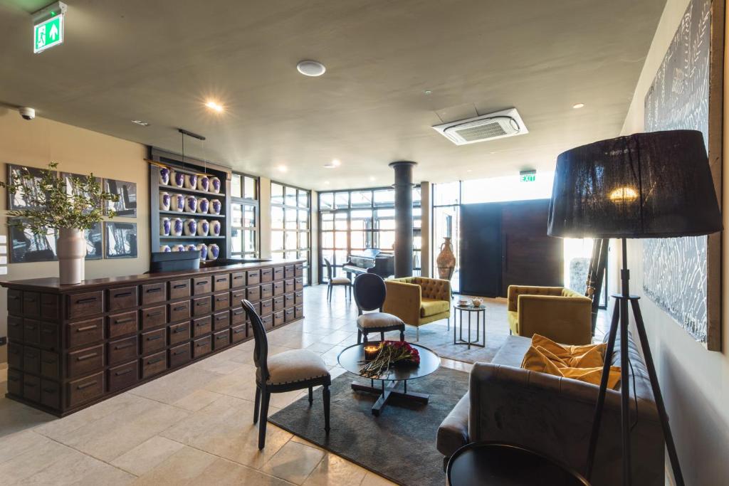 a lobby with couches and chairs in a building at DESIGN hotel VERBENICUM in Vrbnik