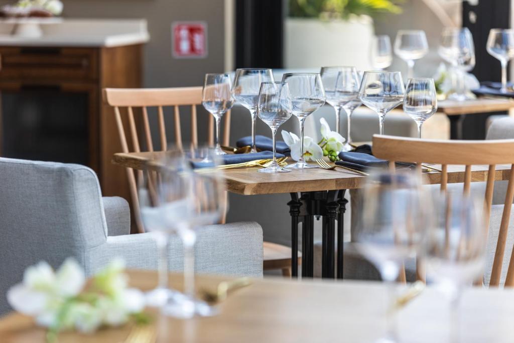 a group of wine glasses on tables in a restaurant at DESIGN hotel VERBENICUM in Vrbnik