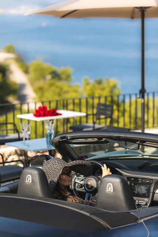 a woman riding in a convertible car at DESIGN hotel VERBENICUM in Vrbnik