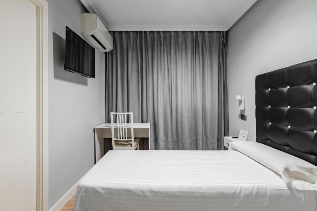 TV a/nebo společenská místnost v ubytování Hostal Los Ángeles
