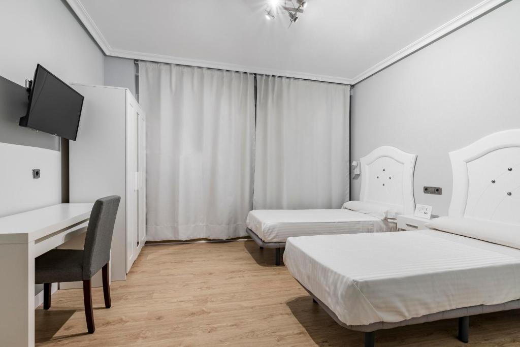 Postel nebo postele na pokoji v ubytování Hostal Los Ángeles
