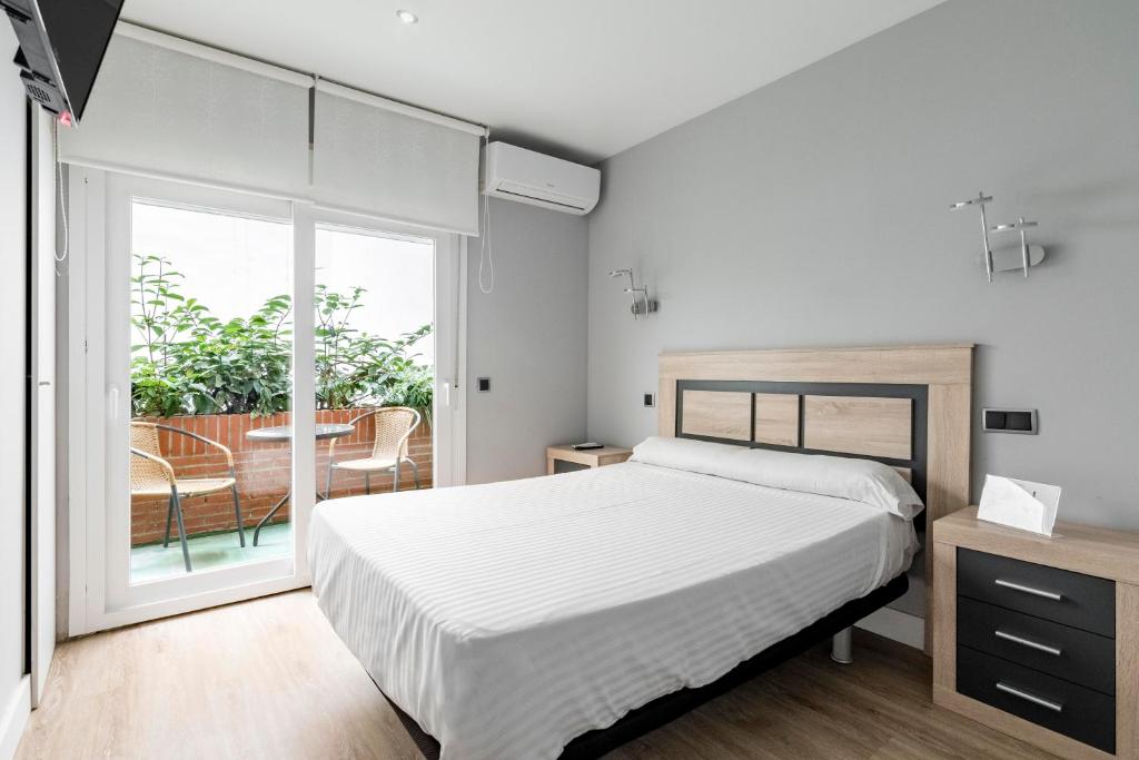 Postel nebo postele na pokoji v ubytování Hostal Los Ángeles