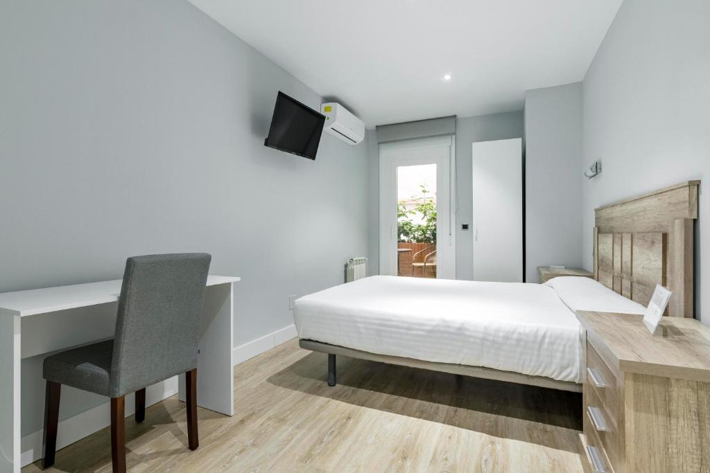 Postel nebo postele na pokoji v ubytování Hostal Los Ángeles