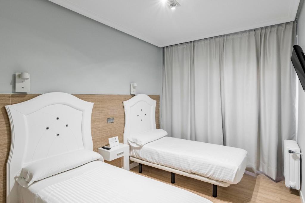 Postel nebo postele na pokoji v ubytování Hostal Los Ángeles