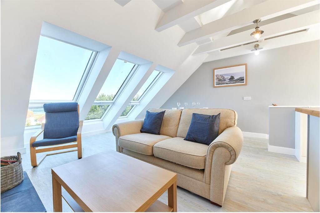 a living room with a couch and a chair at Host & Stay - Castle View in Seahouses