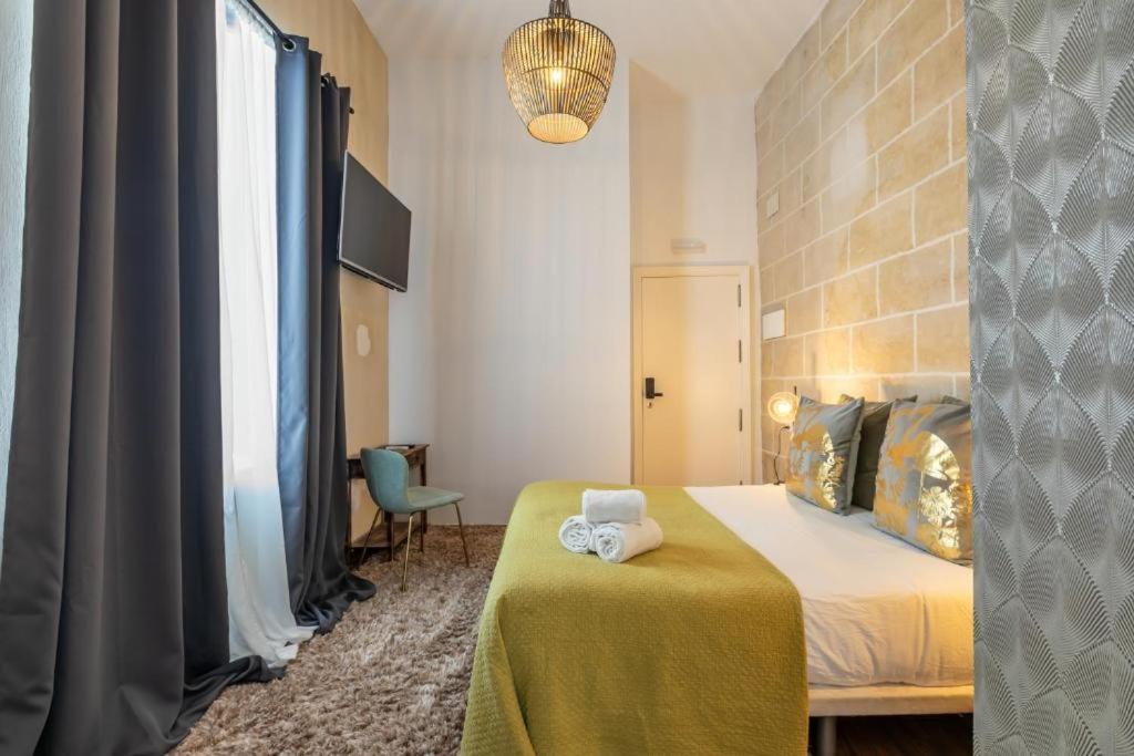 Posteľ alebo postele v izbe v ubytovaní Catedral Suites Jerez