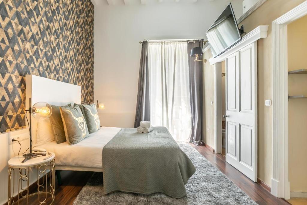 Posteľ alebo postele v izbe v ubytovaní Catedral Suites Jerez