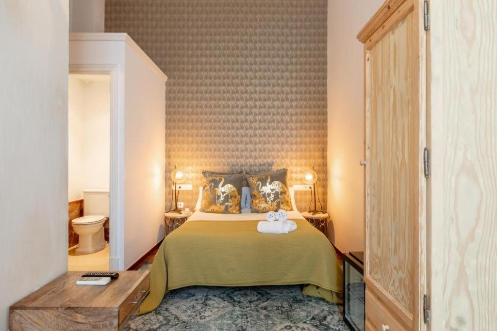 Posteľ alebo postele v izbe v ubytovaní Catedral Suites Jerez