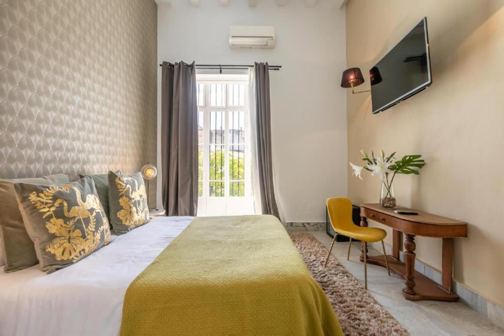 Posteľ alebo postele v izbe v ubytovaní Catedral Suites Jerez
