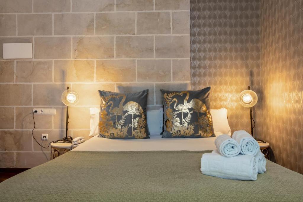 Posteľ alebo postele v izbe v ubytovaní Catedral Suites Jerez