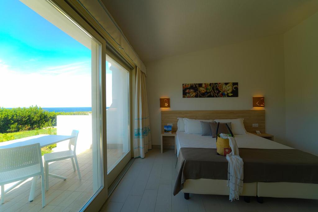 Postel nebo postele na pokoji v ubytování GH Santina Resort & SPA