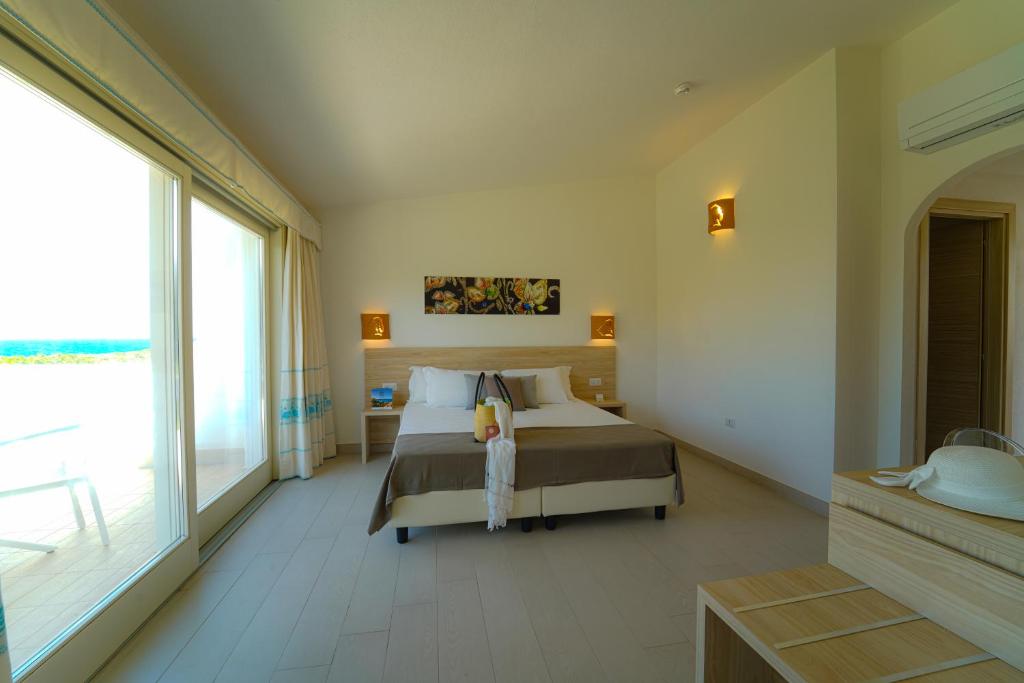 Postel nebo postele na pokoji v ubytování GH Santina Resort & SPA