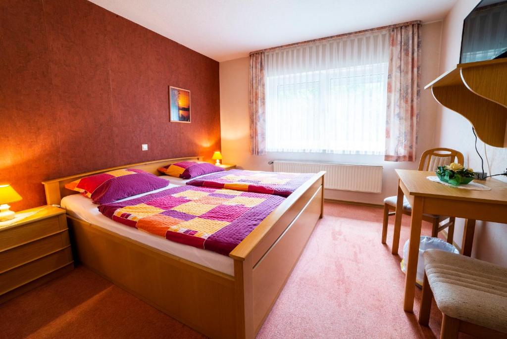 a bedroom with a large bed in a room at Gästezimmer 2 im Landgasthaus Lindenhof in Fresenburg