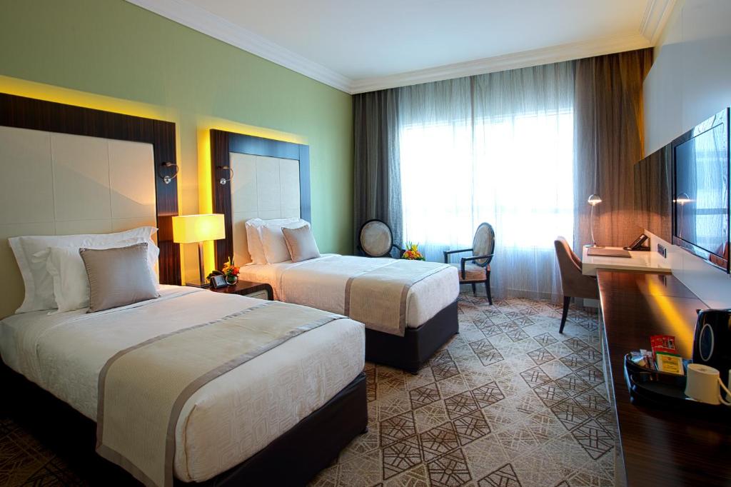 Postel nebo postele na pokoji v ubytování Elite Byblos Hotel