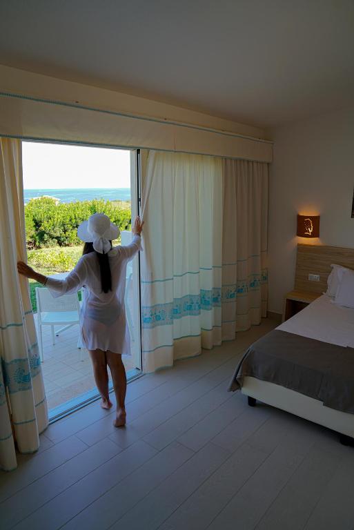 Postel nebo postele na pokoji v ubytování GH Santina Resort & SPA