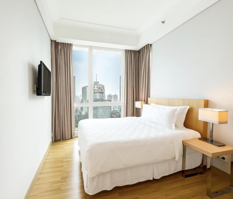 Postel nebo postele na pokoji v ubytování Fraser Residence Sudirman Jakarta