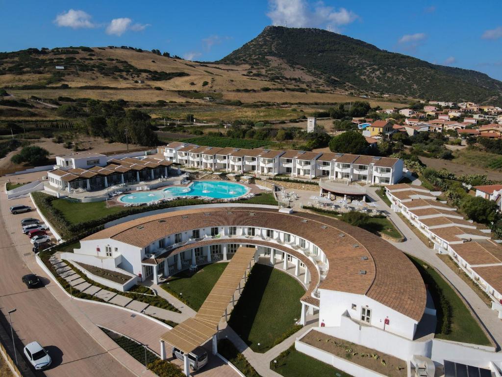 an aerial view of a resort with a mountain in the background at GH Santina Resort & SPA in Valledoria