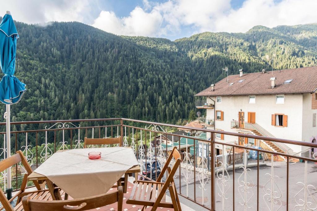 a balcony with a table and chairs and a mountain at Casa al sole in Bresimo