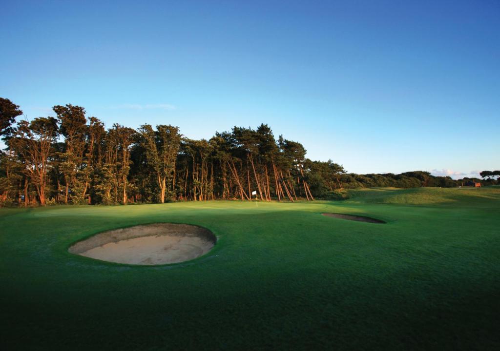 a golf course with a hole in the green at Formby Hall Golf Resort & Spa in Southport