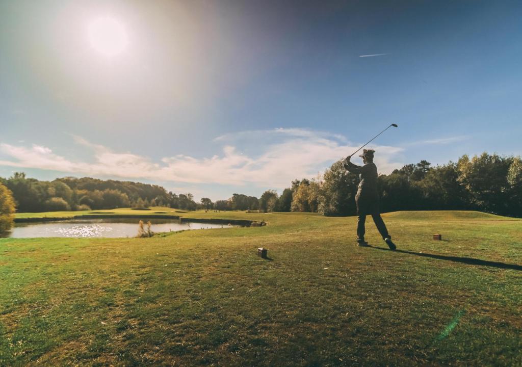 a person is holding a frisbee in a field at Formby Hall Golf Resort & Spa in Southport