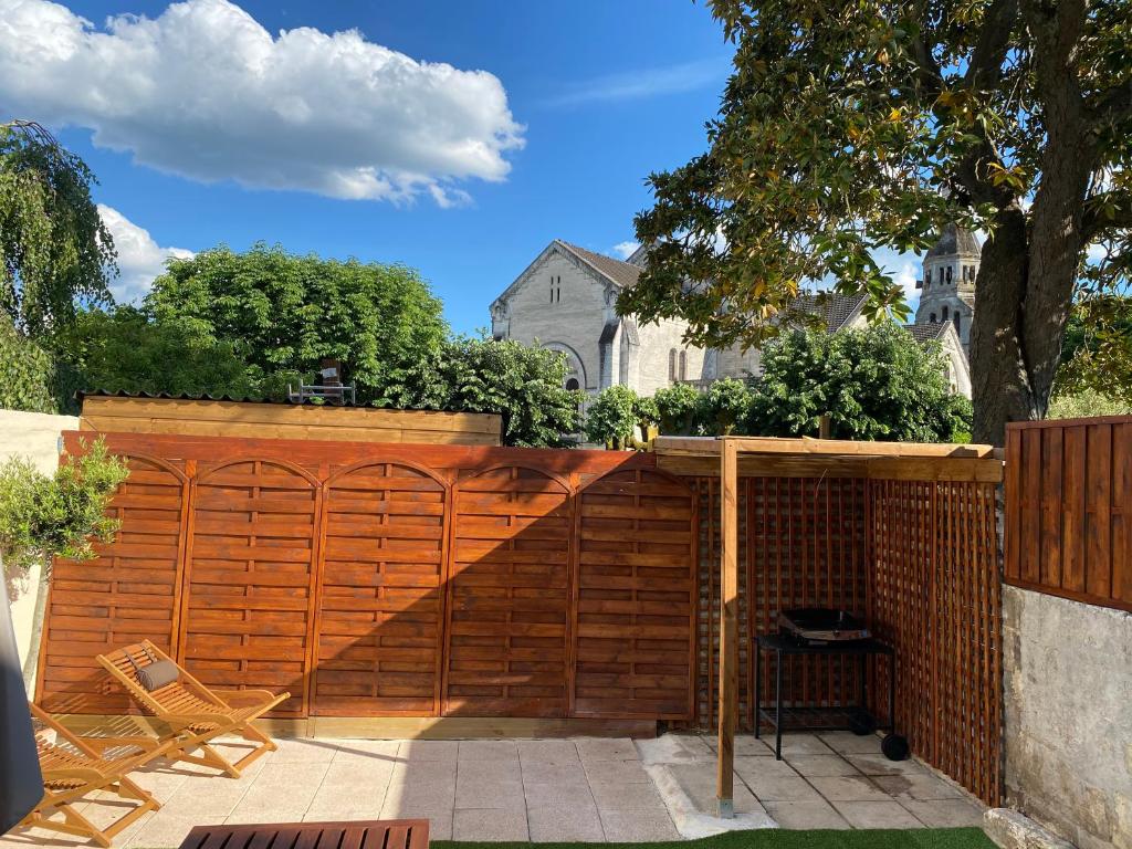 a wooden fence with a wooden gate in a yard at Le Clos Saint Martin in Périgueux