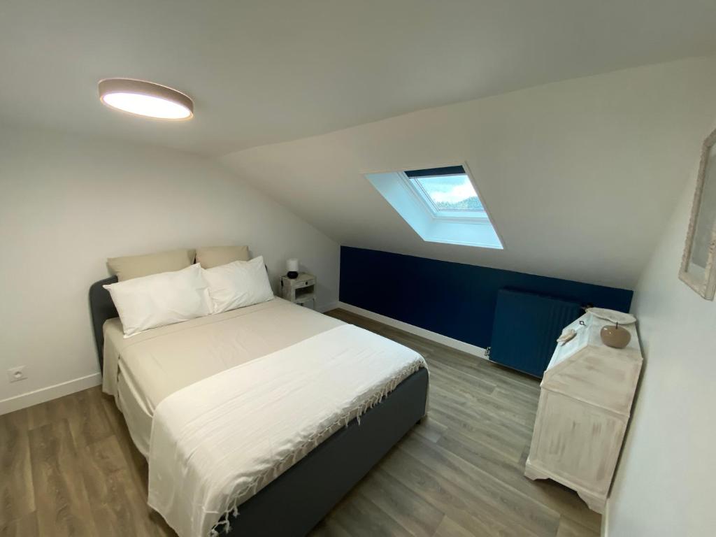 a bedroom with a bed and a skylight at Le Clos Saint Martin in Périgueux