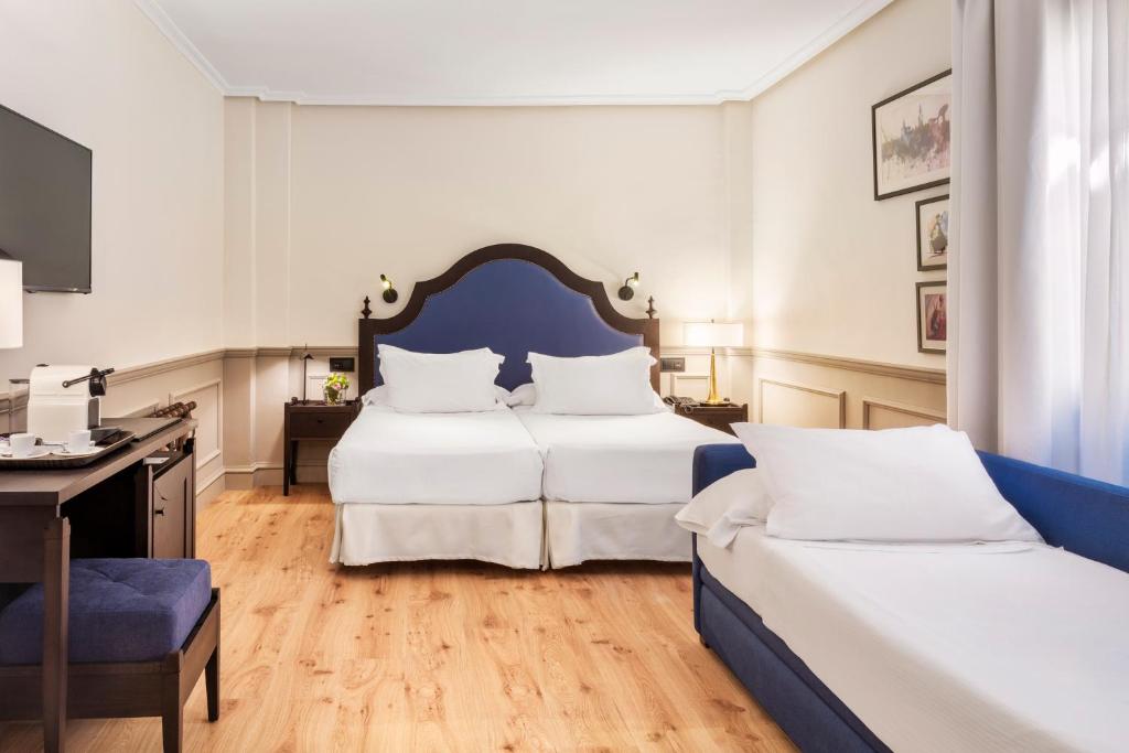Postel nebo postele na pokoji v ubytování H10 Corregidor Boutique Hotel