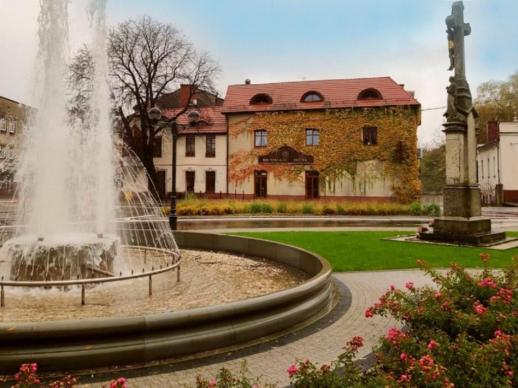 ミコウフにあるRestauracja - Hotel Mocca D'oroの建物の前の公園の噴水