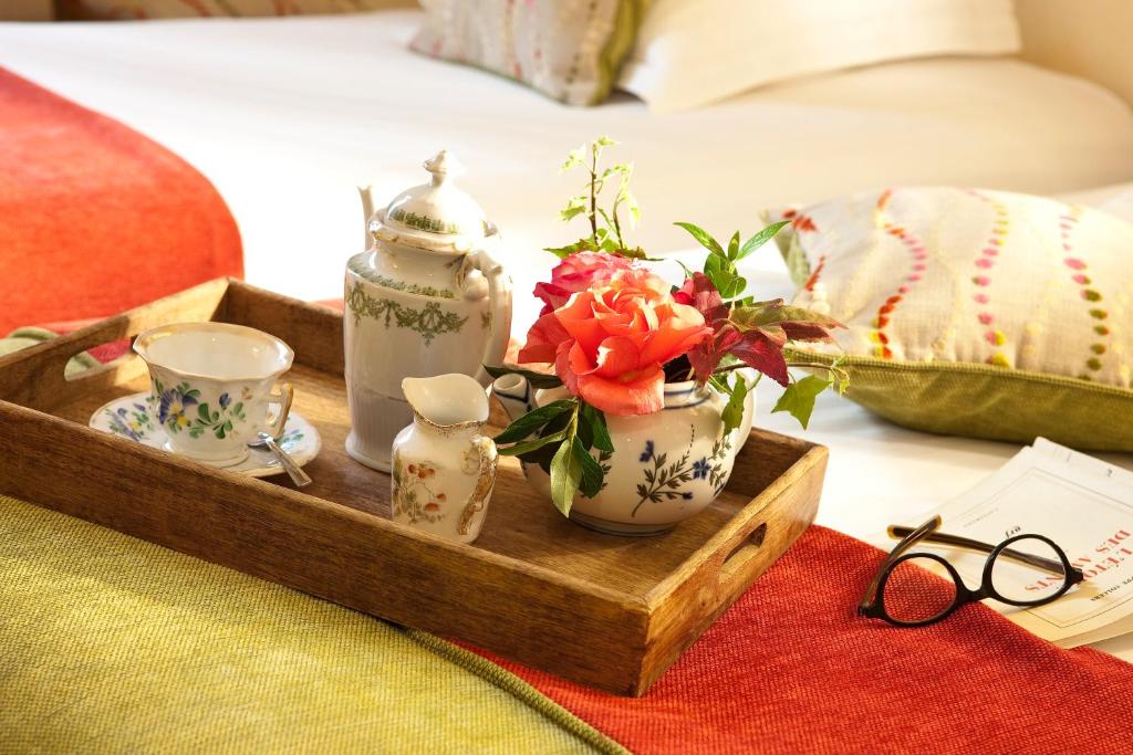 a tray with a tea set and a tea pot and cups at New Orient Hotel in Paris