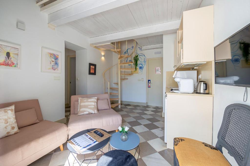 a living room with a couch and a table at La Casa de la Favorita in Tarifa