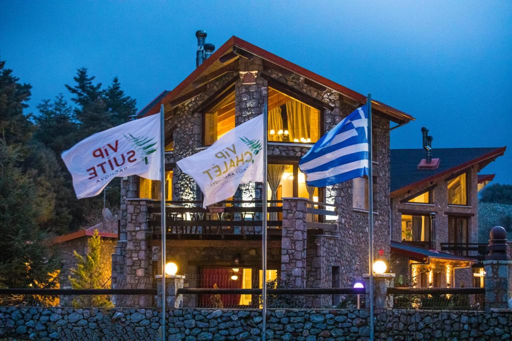a building with flags in front of it at ViP Chalet 4 Seasons in Arachova