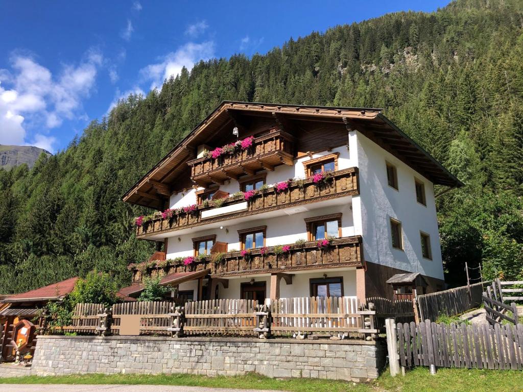 a building with flowers on the balconies of it at Haus Waldruhe in Mallnitz