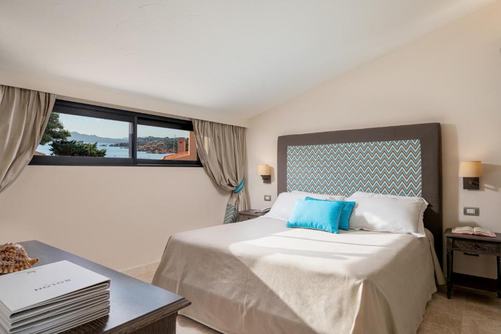 Postel nebo postele na pokoji v ubytování Hotel Cala Lunga