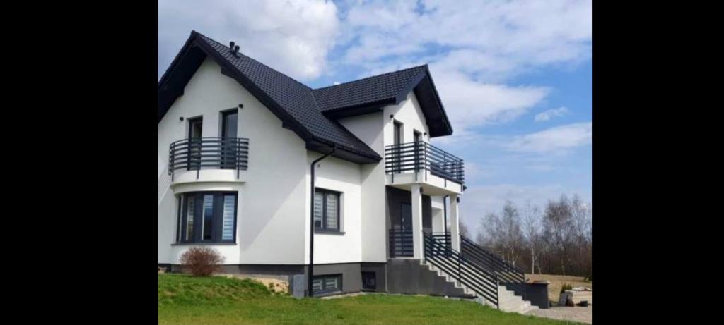 uma casa branca com um telhado preto em Dom u Grzegorza em Kielce