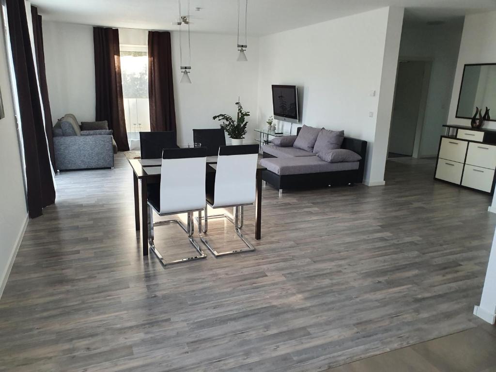 a living room with a table and chairs and a couch at Quiet Place in Achern