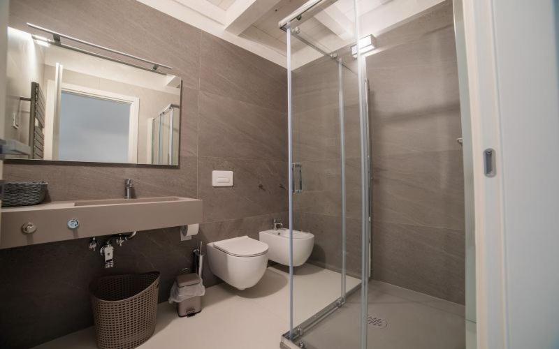 a bathroom with a shower and a toilet and a sink at RESIDENCE OLD STORIES in Barile